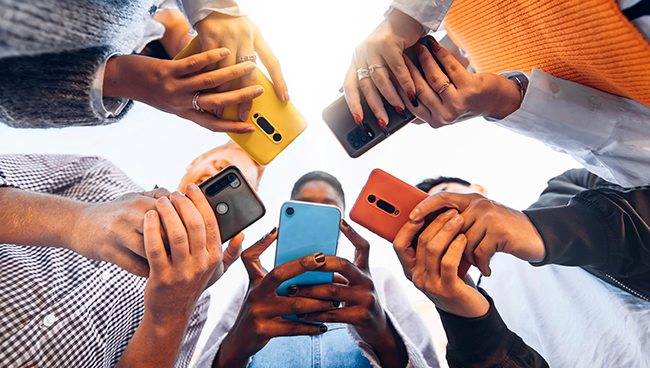 Five people using their smart phones