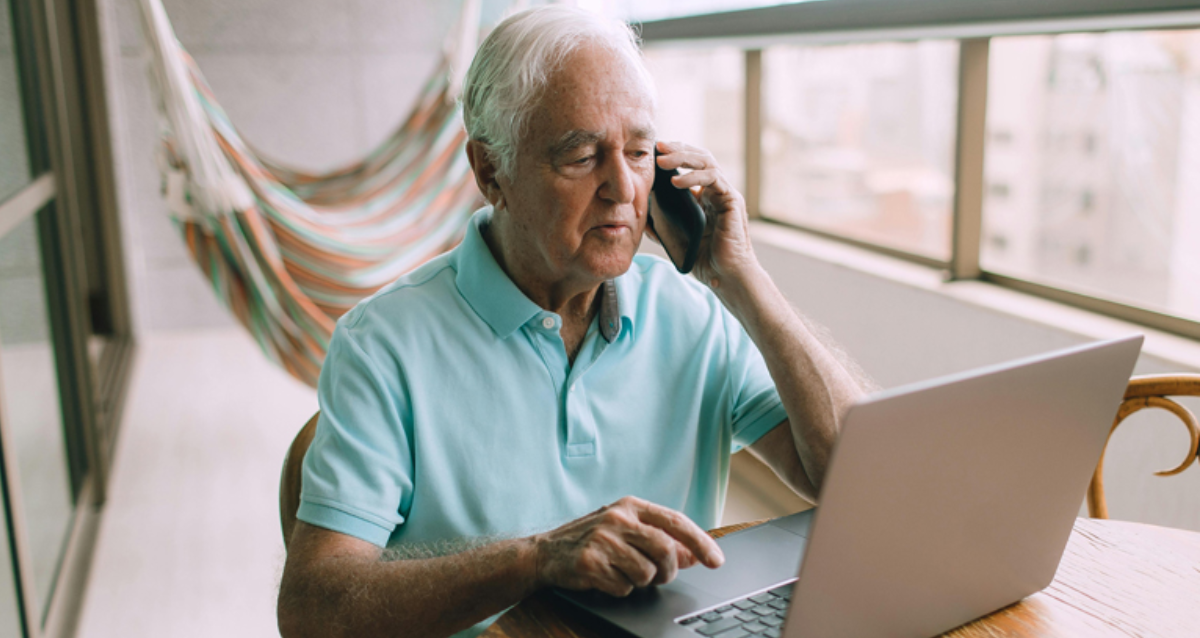 older man on the phone and computer