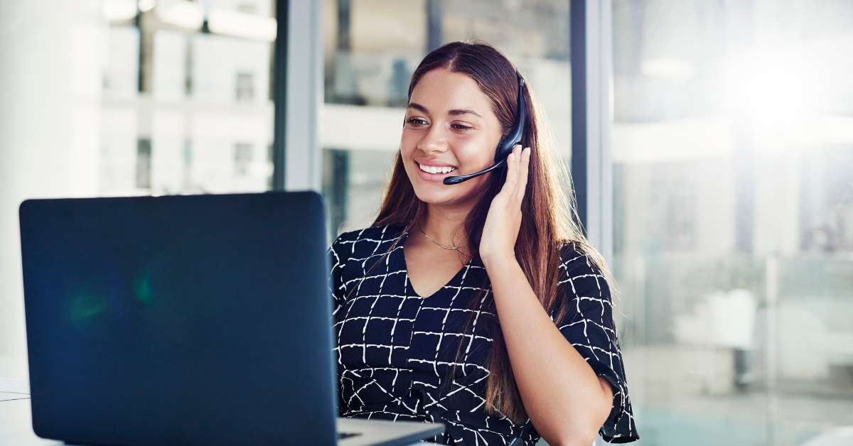 woman using a headset to make a call using a computer