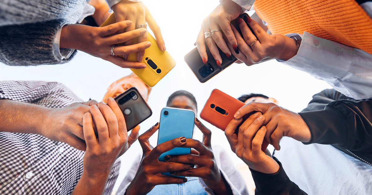 users standing in a circle using their phones