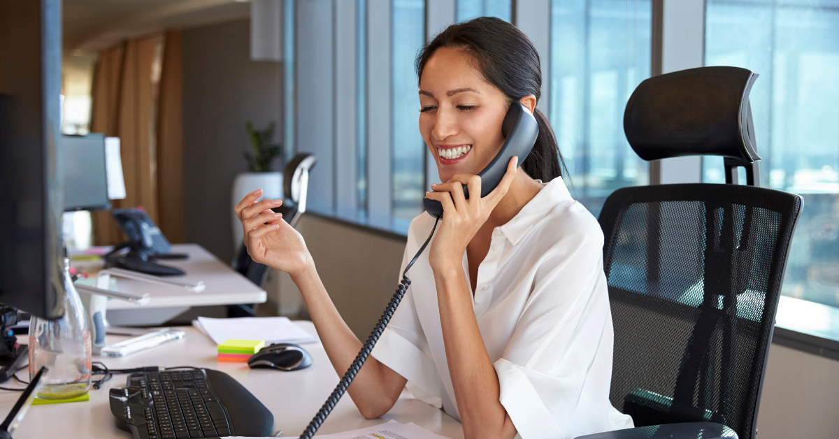 woman talking on a phone in an office