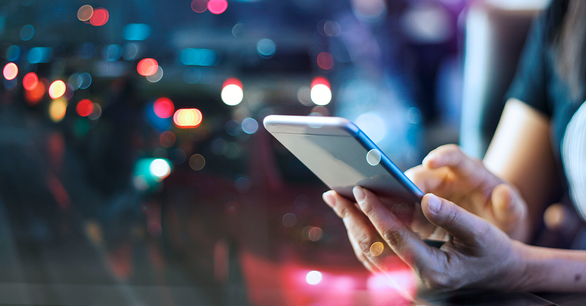 someone using a phone during the evening