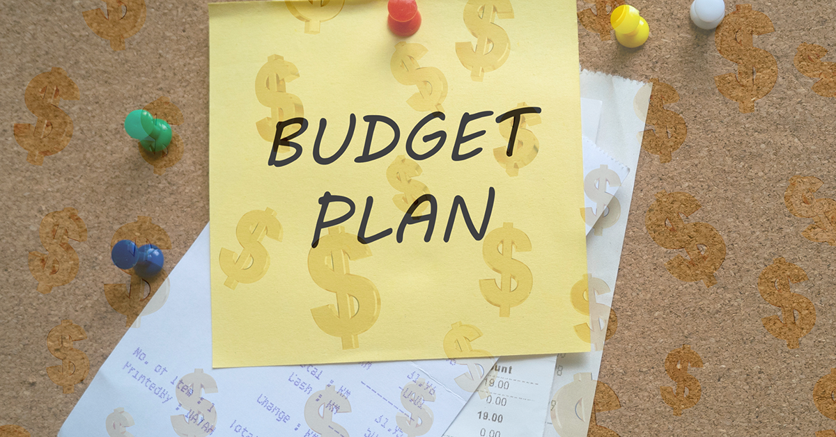 budget plan written on a sticky note on top of receipts