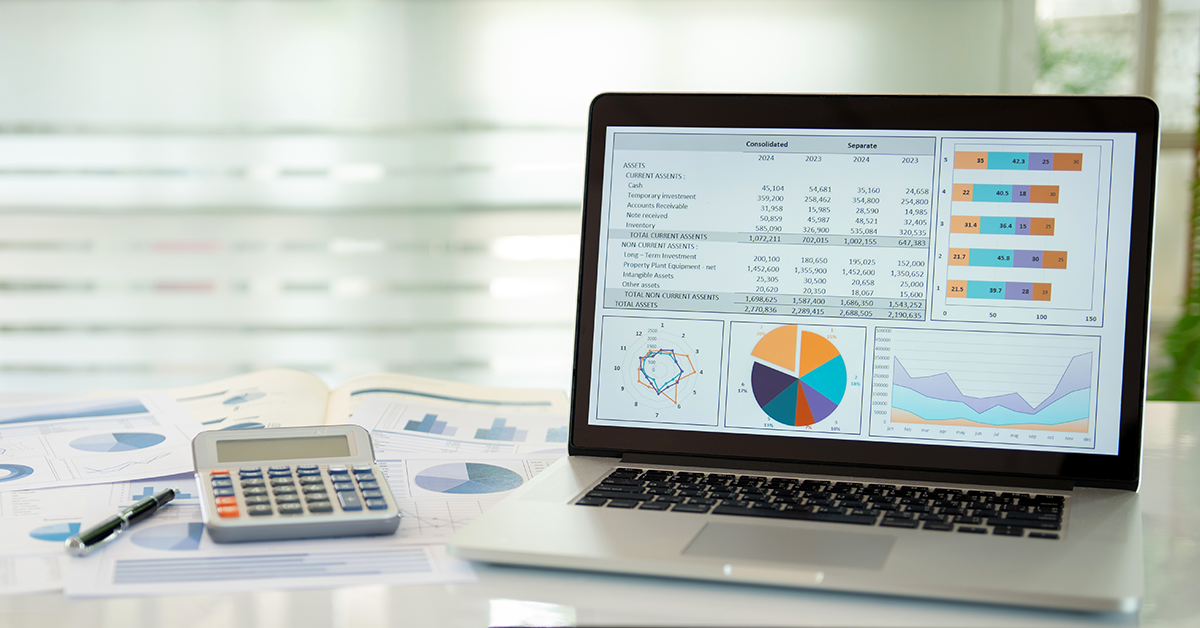 a laptop showing financials on the screen