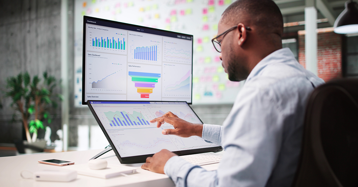 a man assessing analytics using a laptop