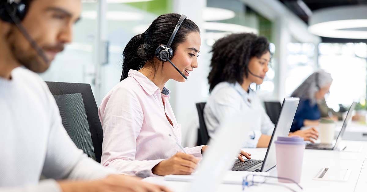representatives at a call center working on laptops