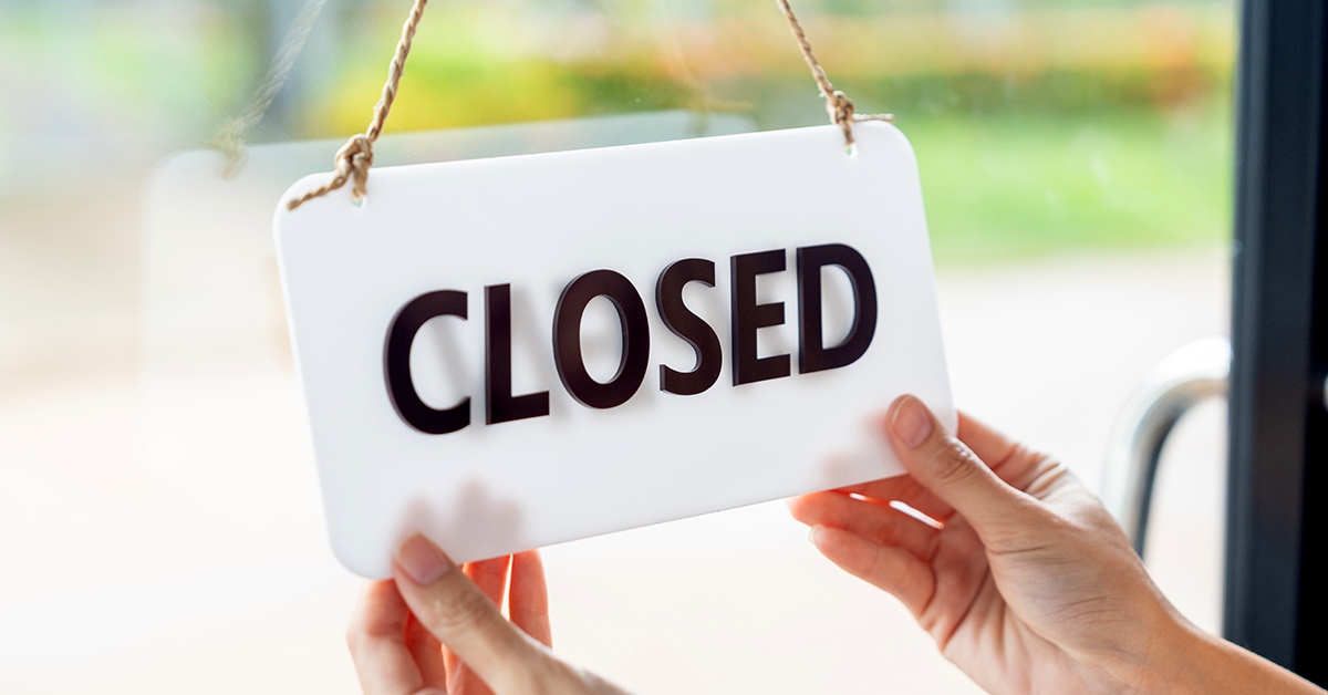 a closed business sign on a clear door