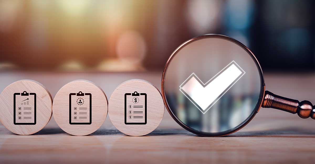 checklist on small wooden disks and magnifying glass