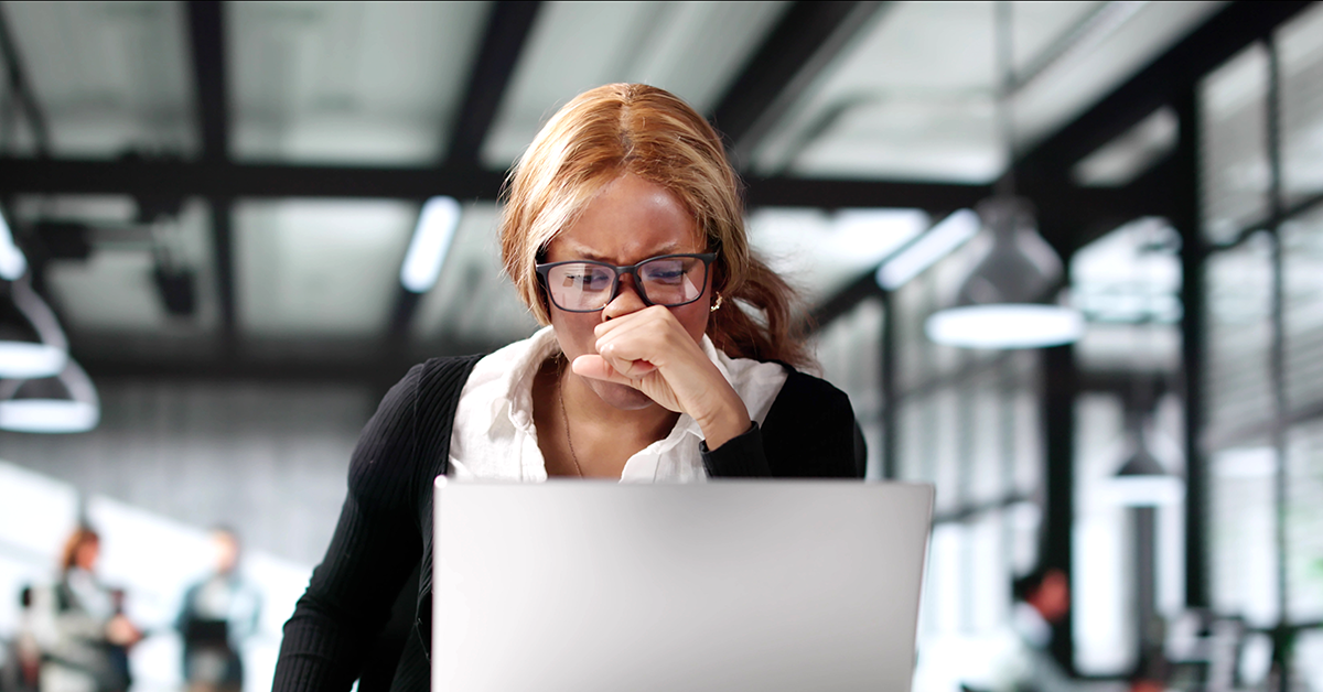 concerned employee looking at a laptop