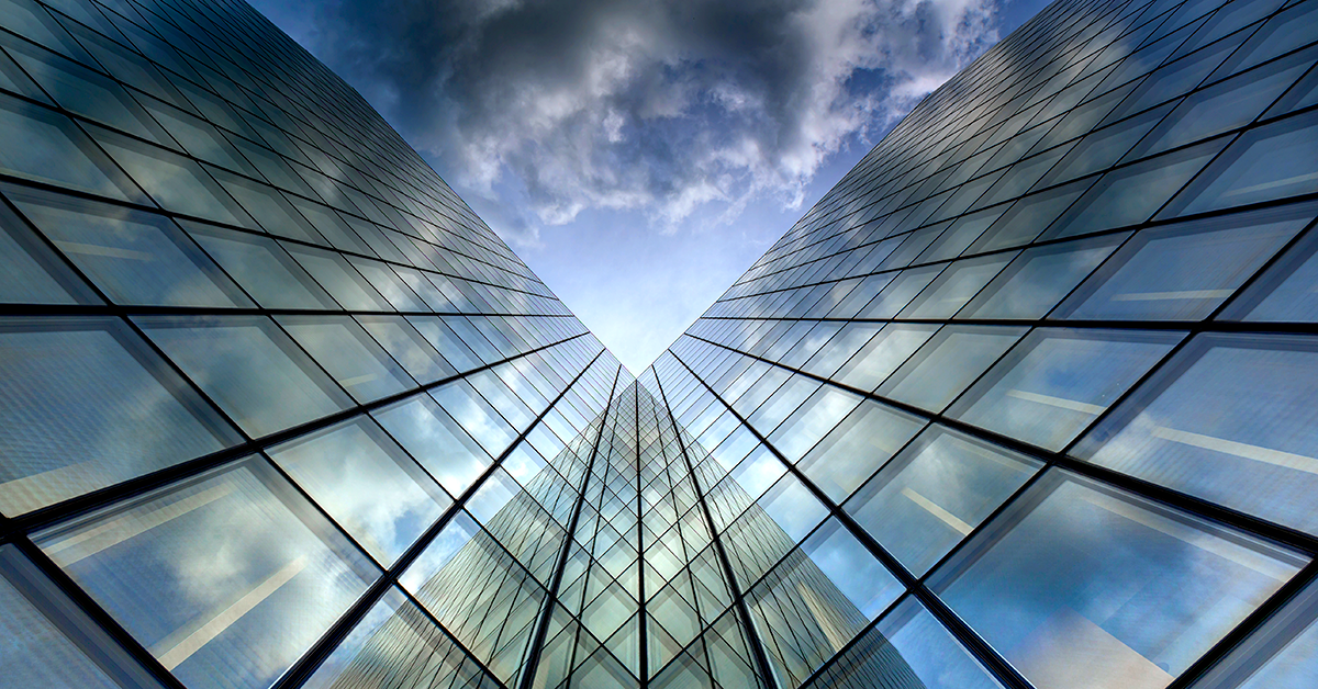 corporate glass building looking skyward