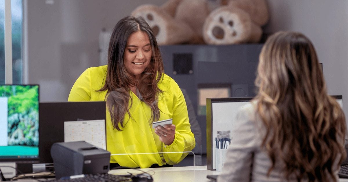 women at a teller station
