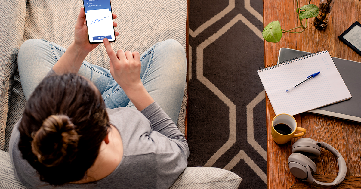 a woman sitting on a couch using her phone