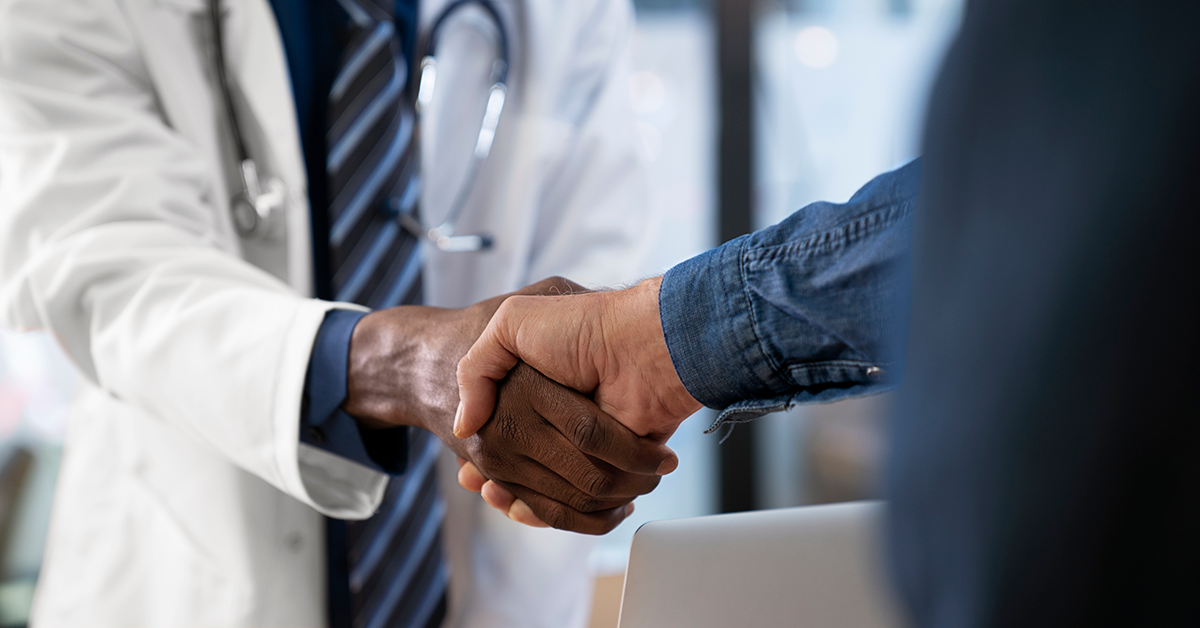 doctor shaking hands with a person