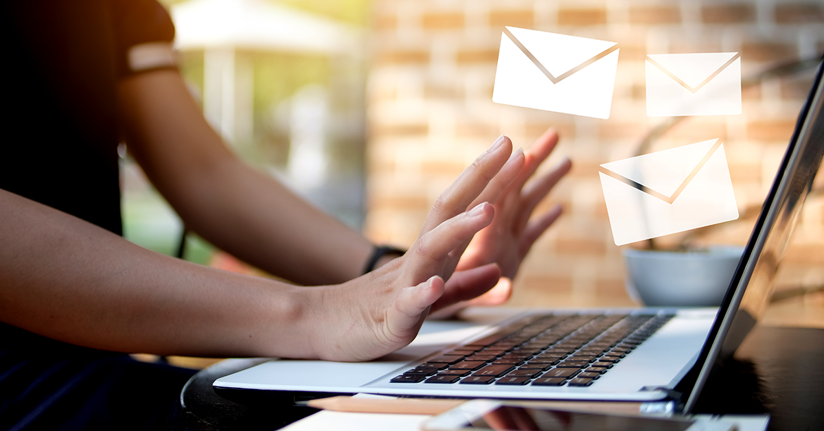 multiple emails flying out of a laptop screen