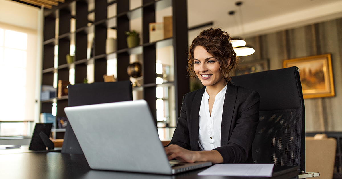executive woman working on a laptop in a conference room
