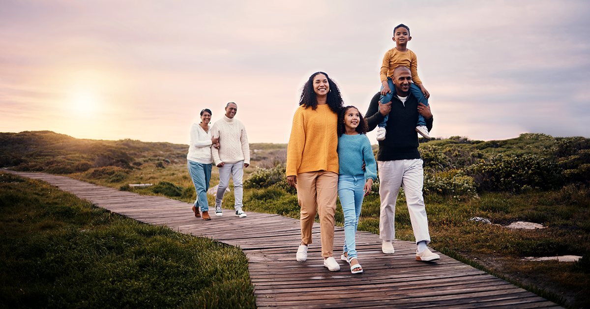 family walking on an oceanside boardwalk