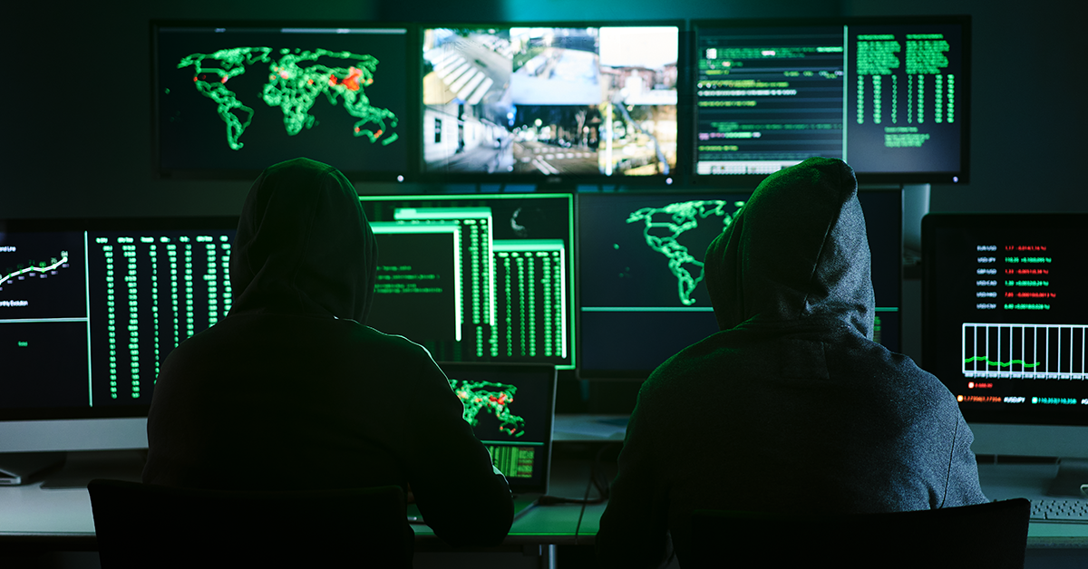 two hackers in a dark room