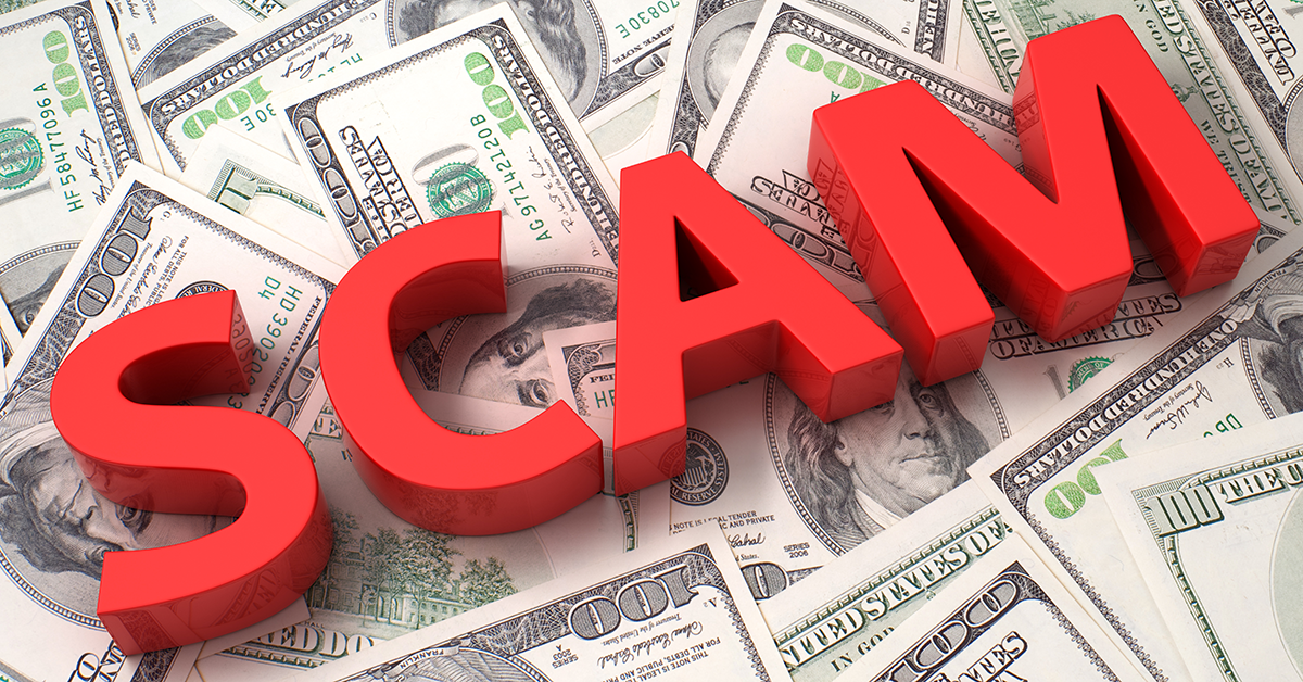 the word scam sitting on top of a pile of money