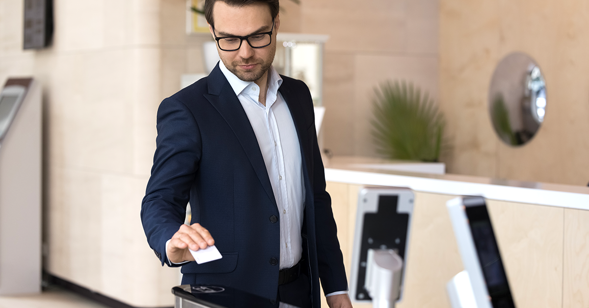a man scanning a badge to enter a building