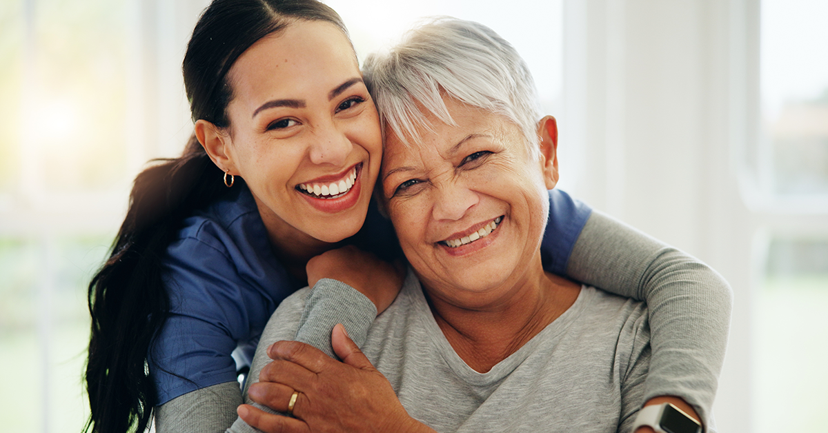a smiling senior with a caregiver