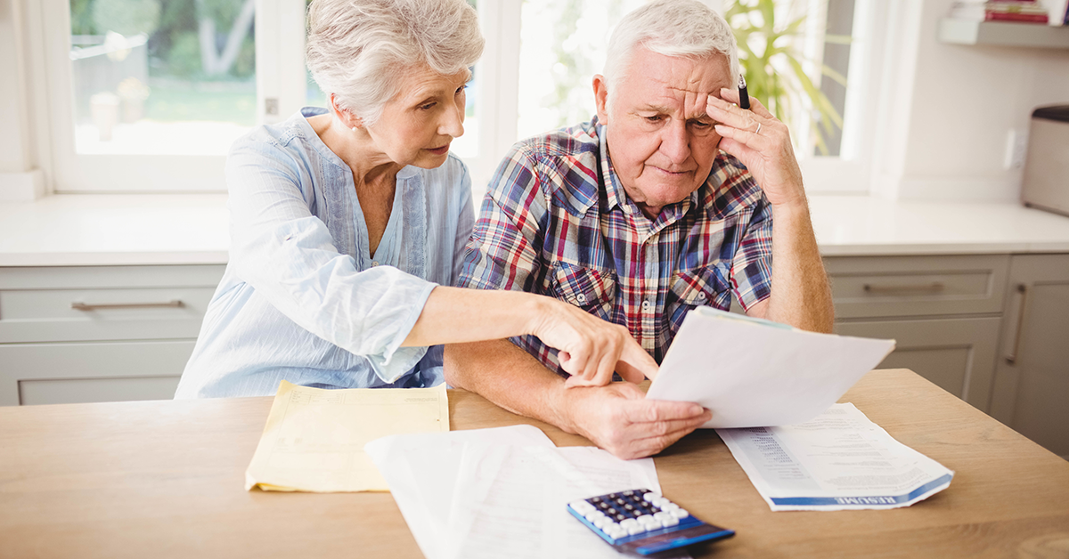 senior citizens reviewing bills