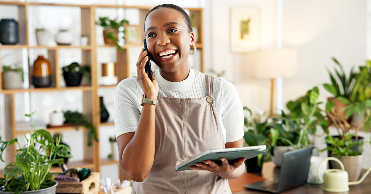 small business owner talking on the phone in a plant shop