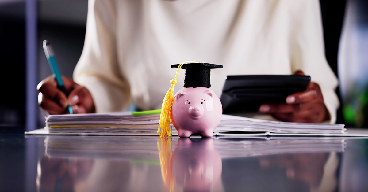 student studying and a savings bank with a grad cap