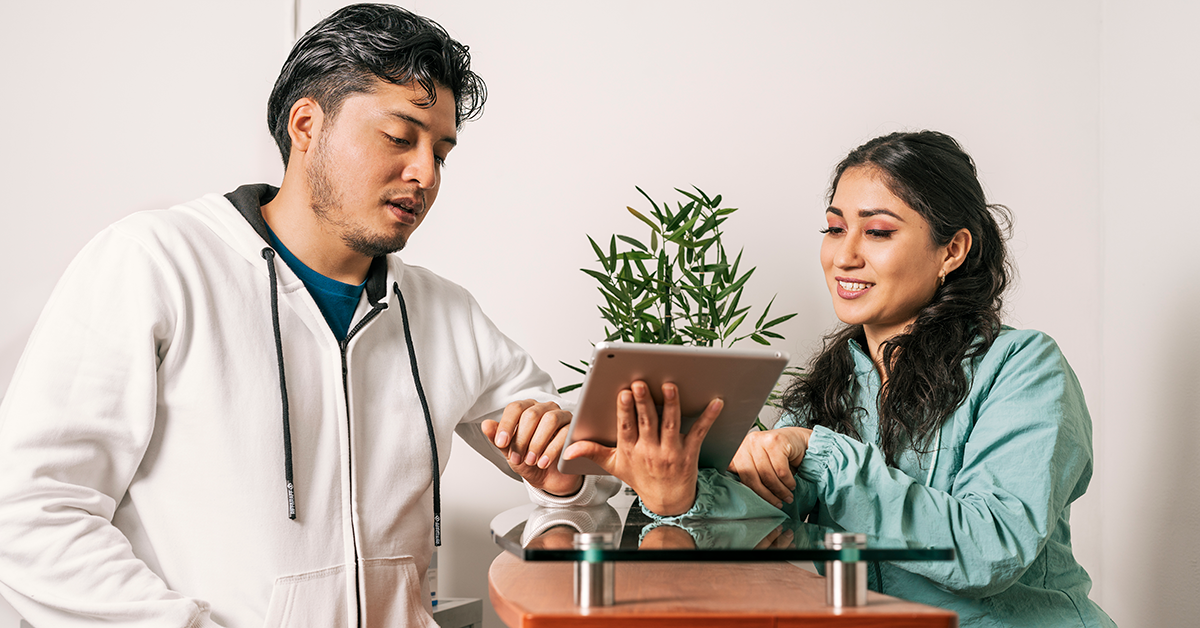 two people looking at a tablet in a mobile office