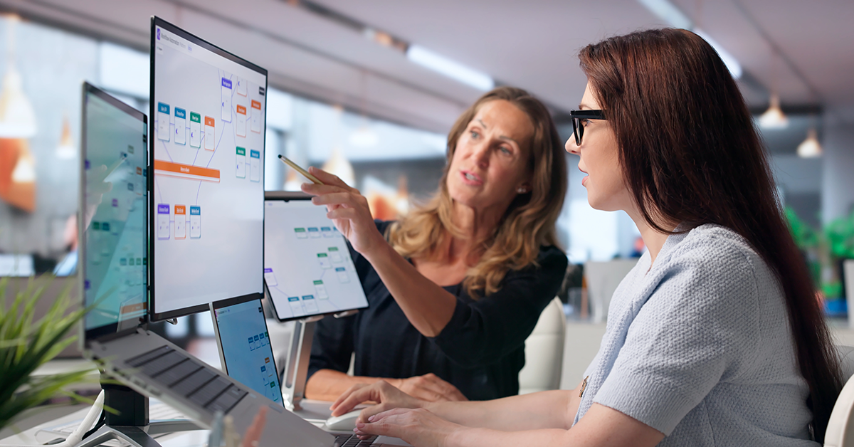 two team members collaborating on a work screen